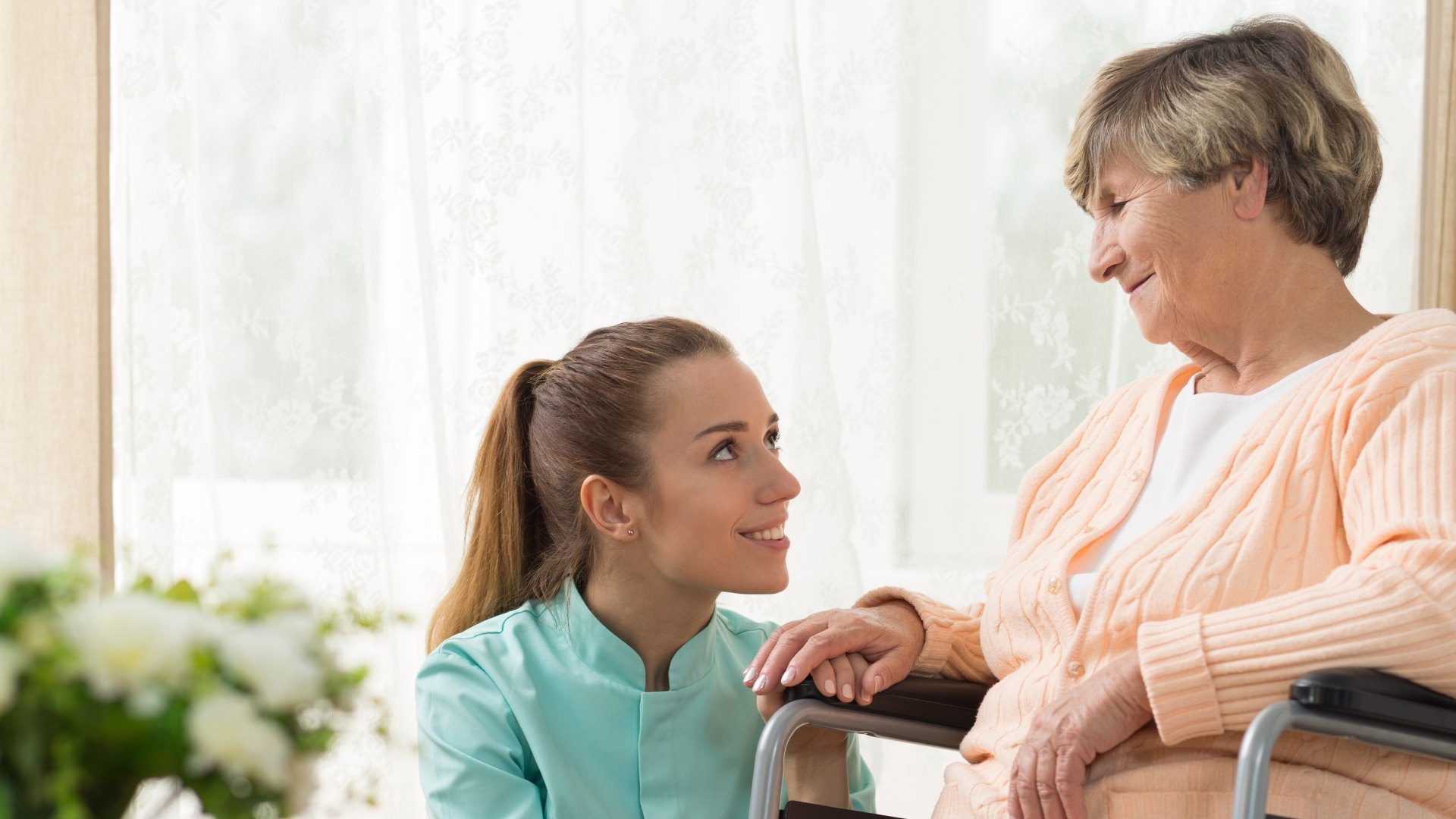 Carer with elderly person in wheelchair