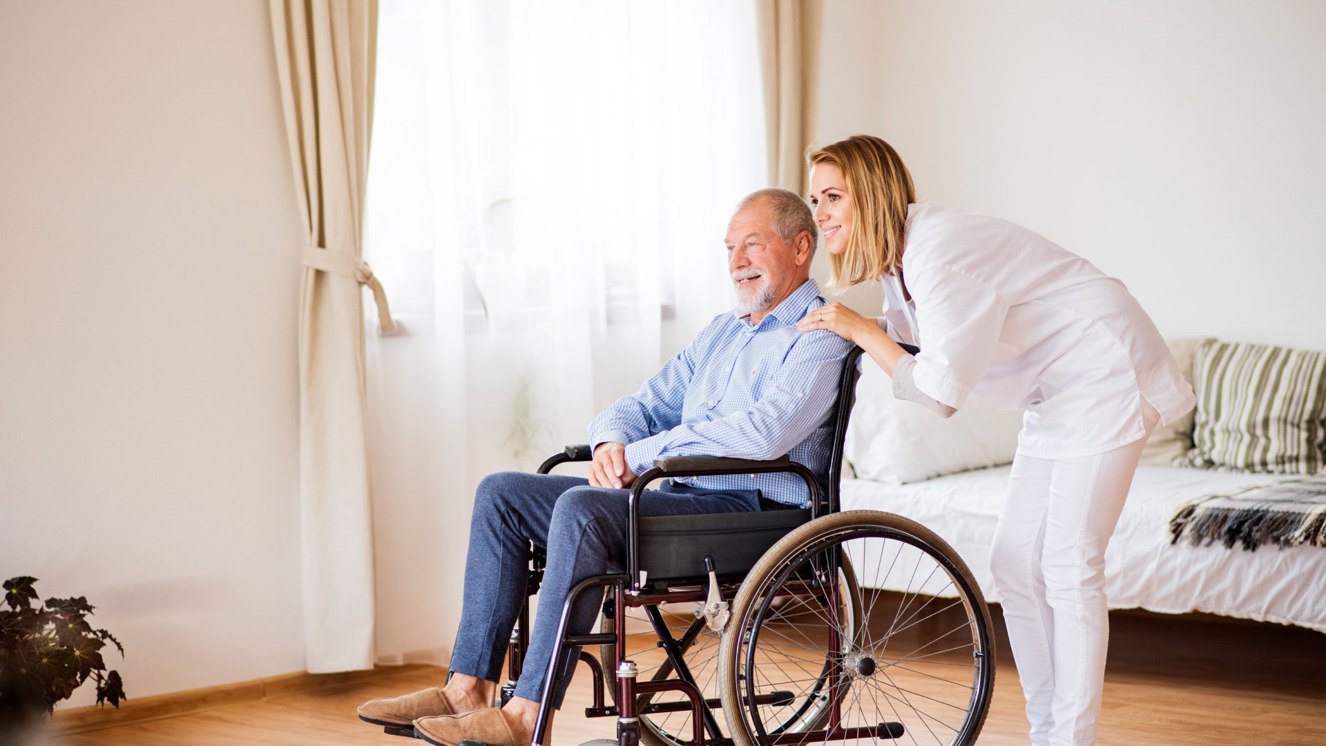Carer assisting elderly person at home